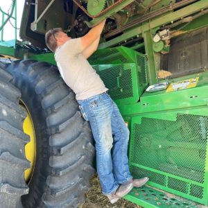 Tommy fixing combine